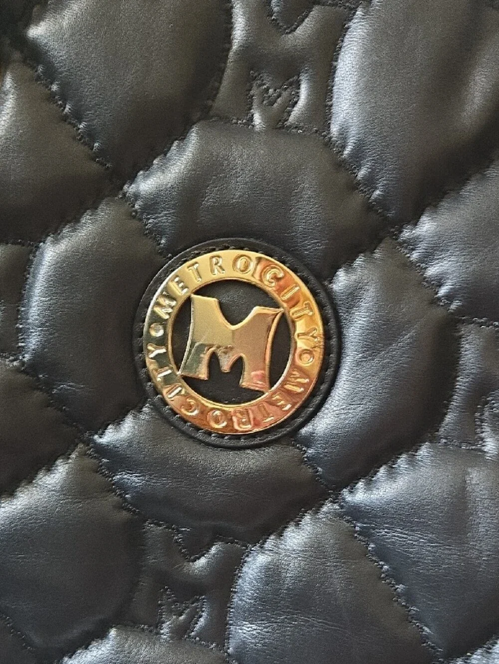 Quilted Black Tote with Gold Medallion Accent